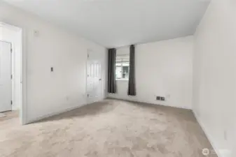 Main bedroom features brand-new carpet, fresh white paint, walk-in closet, & additional access door to the bathroom. Virtual staging to showcase potential furniture placement.