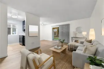 Ground-floor corner unit living room with brand-new LVP flooring, fresh white paint, and virtual staging to show furniture layout.