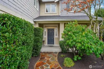 Slab stone walkway leading up to porch and front door.