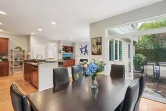 Dining space connected to kitchen and living room, for modern open concept living.