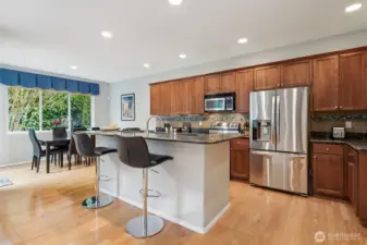 Chef's kitchen with custom slab granite counters.