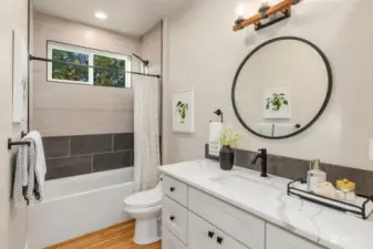 First floor full bath with lots of counter space and linen cabinet