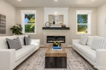 Cozy living room with mosaic tiled fireplace, rustic wood mantle and shiplap.