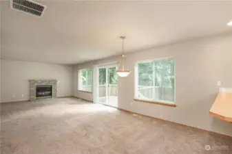 Family room with gas fireplace. Open to the kitchen and dining area. Sliding glass doors leading to the rear deck and private backyard