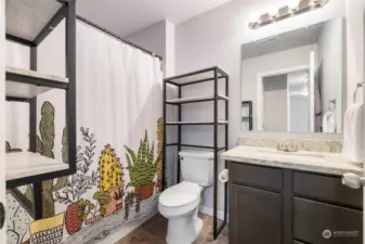 3rd floor full bath with matching countertops to kitchen.