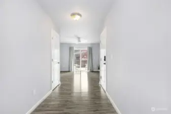 Entry at ground level, wide hallway leading to possible MIL space or recreation room, full bath & a bedroom. Deck outside of the sliding door. Fully fenced yard. Entry from garage is to the right.