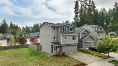 3 story home with community lot next to it. Lovely front porch!