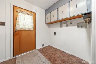 Laundry room with cabinets.