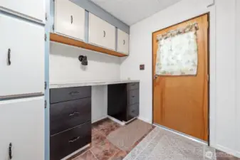 Large laundry room with plenty of cabinets and counter space.