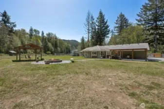 Multiple outdoor living spaces with large firepit off the living room side of the house.