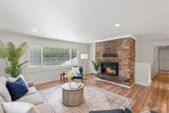 The living room enjoys a wood burning fireplace, laminate easy-care flooring, and can lighting.