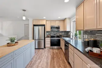 The island has butcher block counters and loads of storage underneath.