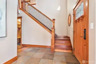 The welcoming front entry with vaulted ceilings and wood staircase
