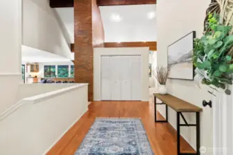 Entry with hardwoods and vaulted ceilings.