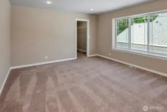 Bedroom with walk-in closet on upper floor