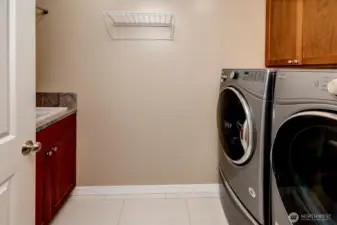 Utility room with W/D, utility sink and floding area.