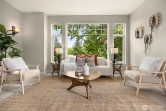 Family room with views of the golf course and evergreens.