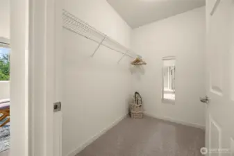 Spacious primary walk-in closet.