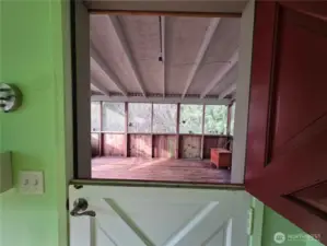 Dutch door from primary bedroom to screened porch that leads to hot tub,