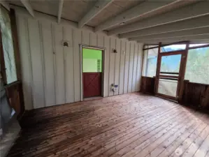 screened covered porch off the primary bedroom, leads out to the new salt water hot tub