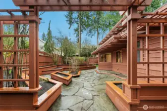 Stone-paved patio area with raised garden beds