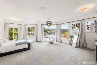 The main floor primary suite is a retreat with views down the bay towards the Olympic Mountains