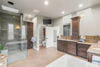 The 5-piece primary bathroom offers plenty of counter space and storage, a large walk-in shower , bidet toilet, and a jacuzzi tub complete with a ceiling filler