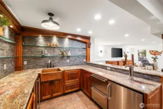 The bar is complete with a built-in tap/kegerator, dishwasher, ice machine, wine fridge & refrigerator...not to mention a 300-bottle wine room