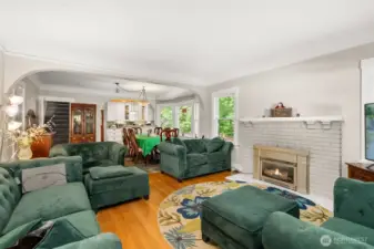 Enter to the grand living room.  Coved ceilings, fireplace, hardwood floor.