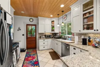 Modern kitchen, quartz/granit counters, modern appliances,  door to back porch.
