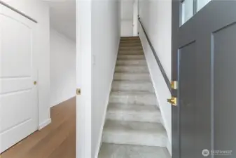 Coming from the second entrance, to the part with a bedroom on this level, and going up to the kitchen and living area.