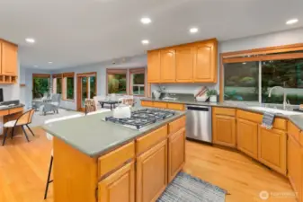Gas range in kitchen with offset bench nook and oversized island with seating