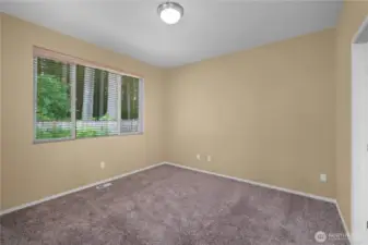 Large primary suite with view of the backyard.