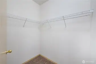 Large walk-in closet in primary suite.