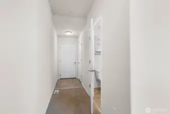 Hallway leads to the attached two car garage. Convenient powder room on the right.