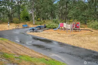 Playground with slide and picnic tables.