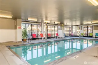 Indoor heated pool with plenty of chairs and natural light