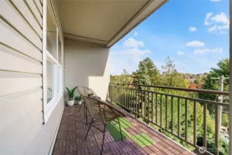 Enjoy morning coffee or dining al fresco on this private balcony.