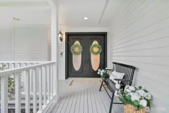 Wrap around porch with grand doors.