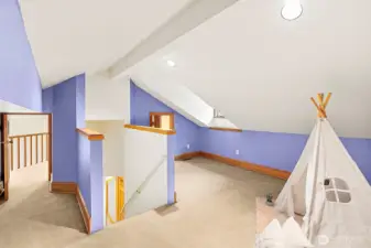 Loft space with two small doors leading to balcony's.