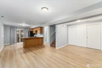 Living room looking towards kitchen and glass sliding doors leading to the private patio.