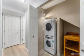 Main level hallway with washer and dryer looking towards the bathroom.