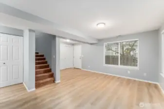View of living room, entryway and stairs to the upper level.