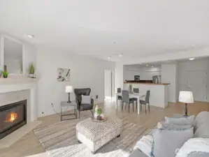Living area with gas fireplace and open layout connecting to dining area and kitchen. Functional floor plan with defined living and entertaining spaces.