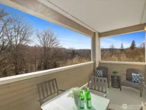 Large private covered deck with extended views of surrounding trees and greenbelt, offering additional outdoor living space with open outlook.