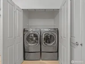In-unit laundry with washer and dryer and dedicated closet space for everyday use.
