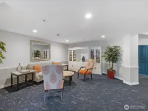 Shared community space with seating area and built-in cabinetry, providing common recreation and gathering area within the building.