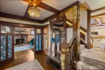 Second view of the entry with ornate details.  Split landing on the stairwell from the entry & the kitchen.  Beautiful wool carpet highlights the rich wood finishes.