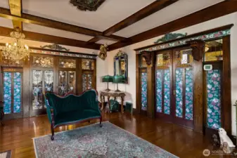 doors to the right are to the entry, glass paneled doors open to the dining room.
