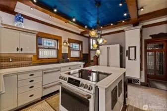 Painted tin ceiling inset with accent lighting is one of many lit details in the kitchen.